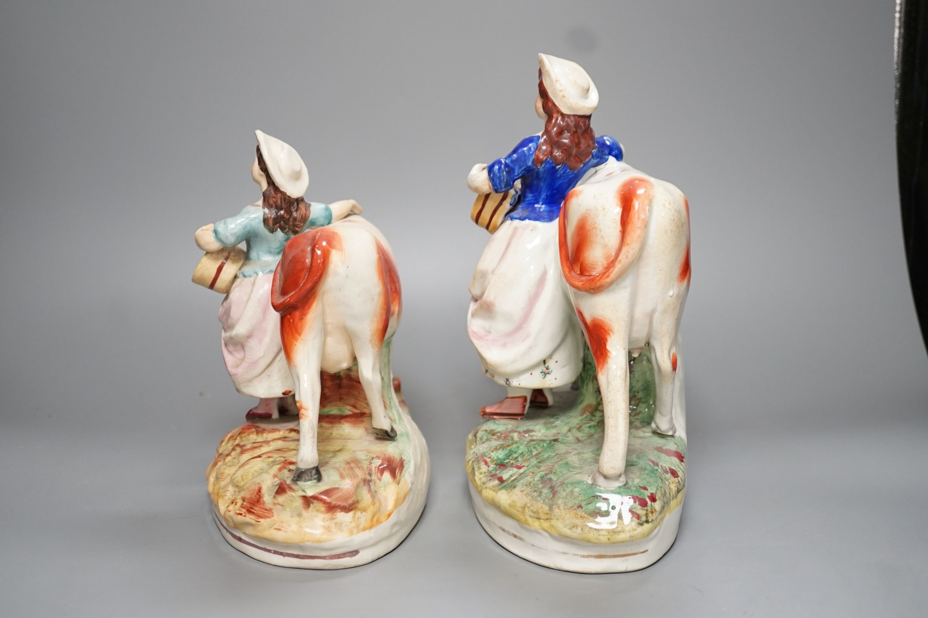 Two 19th century Staffordshire milk maid groups - tallest 24.5cm